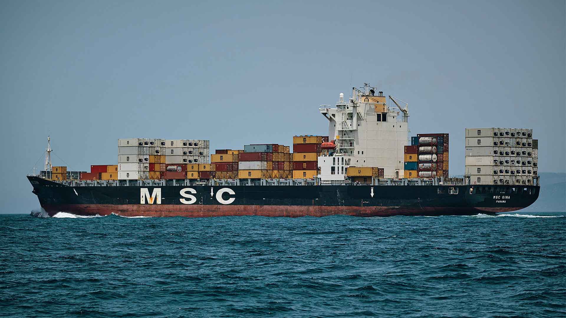 Air freight moving above cargo cranes